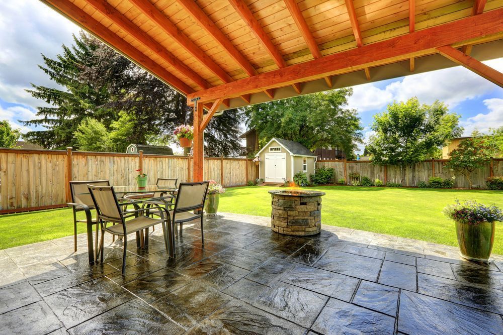 Covered outdoor living space featuring a dark stamped concrete floor.