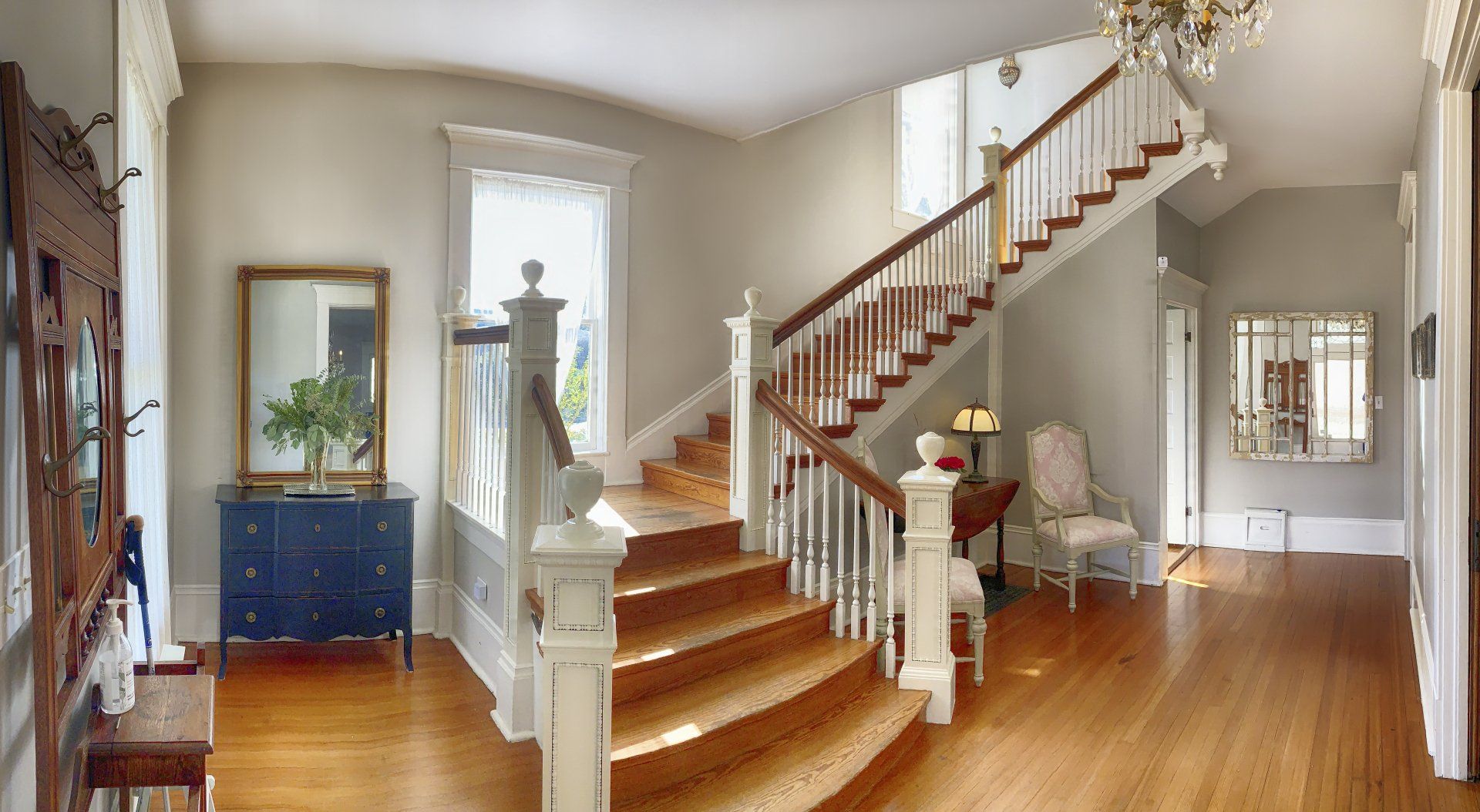 A large hallway with stairs leading up to the second floor