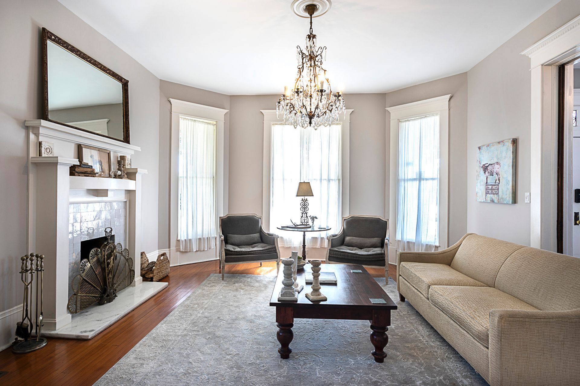 A living room with a couch and chairs and a fireplace