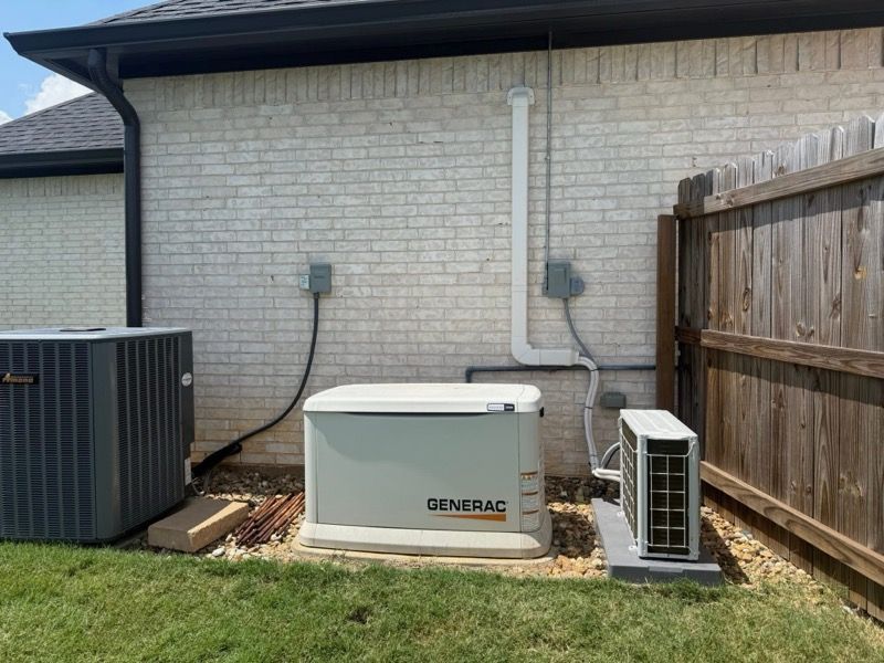 A generator is sitting on the side of a house next to an air conditioner.