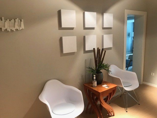 Ein Wartezimmer mit zwei Stühlen und einem kleinen Tisch