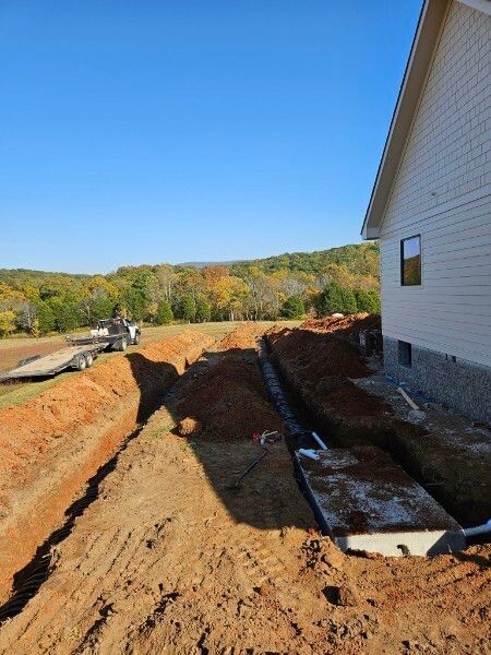 A house is being built in the middle of a dirt field.