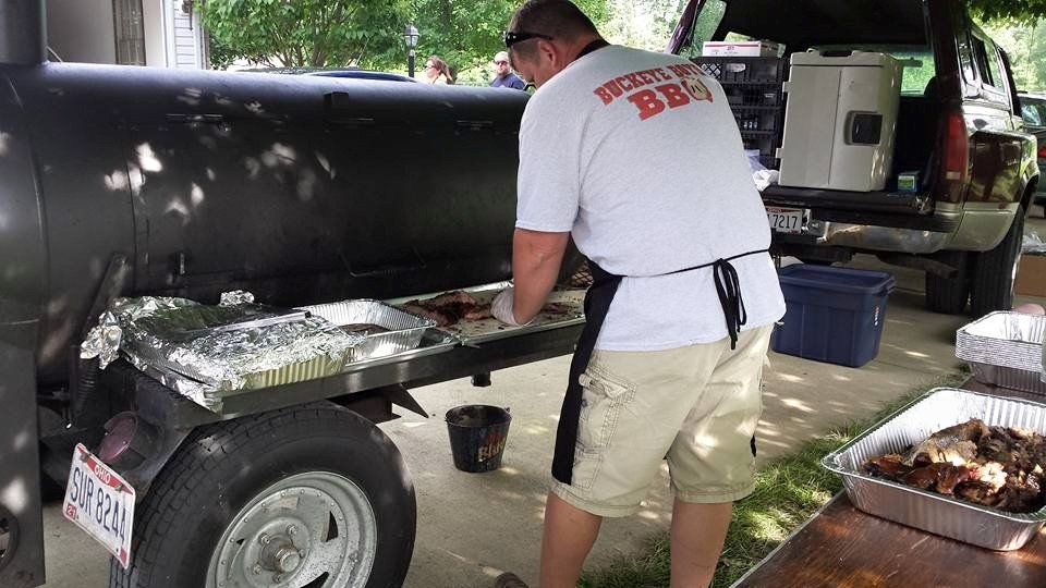 A man in a white shirt with the word bbq on it