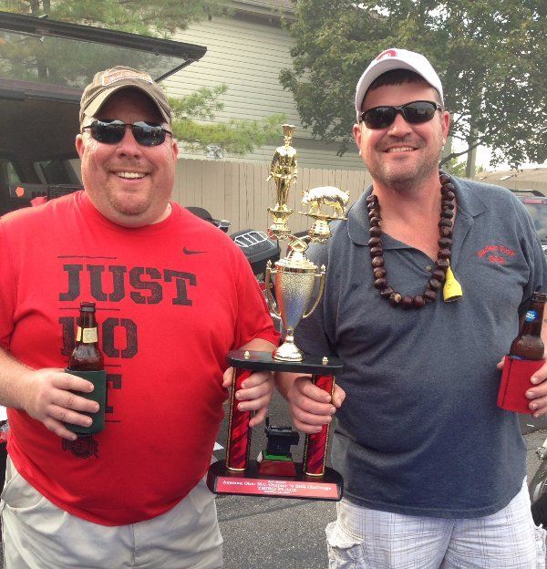Two men standing next to each other one wearing a red shirt that says just 10
