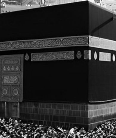 A black and white photo of a crowd of people in front of a building.