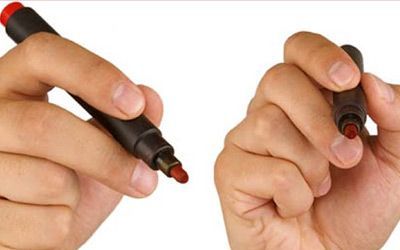 A person is holding a red marker in their hand