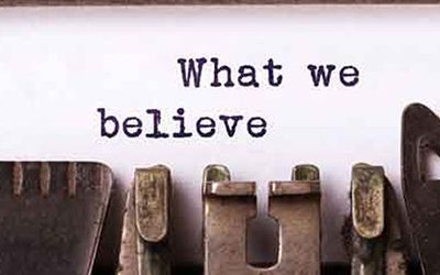 A typewriter with the words `` what we believe '' written on it.