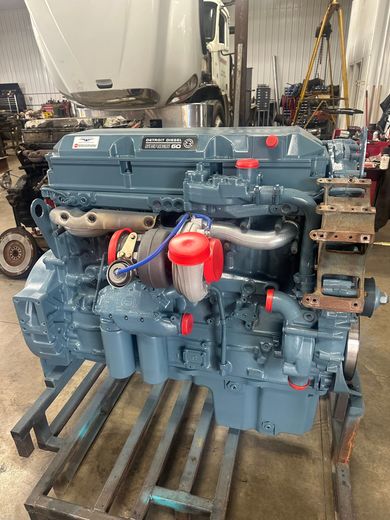 A close up of a car engine with the hood open