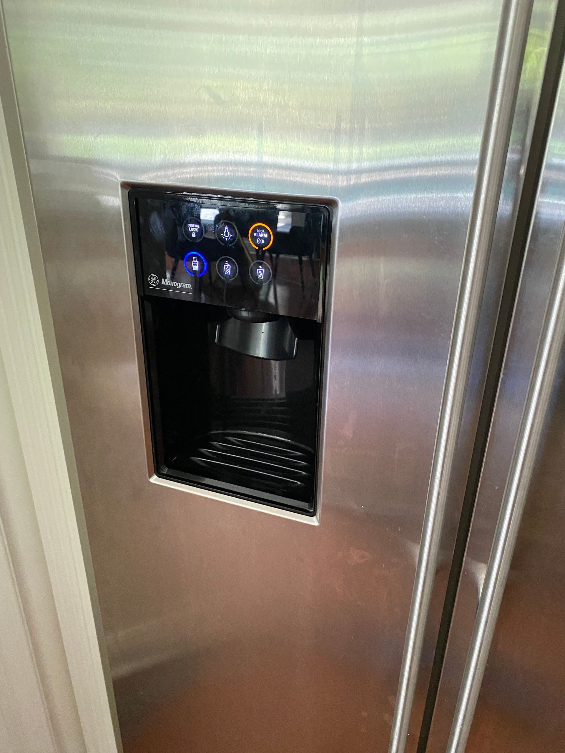 Stainless steel refrigerator with water and ice dispenser.