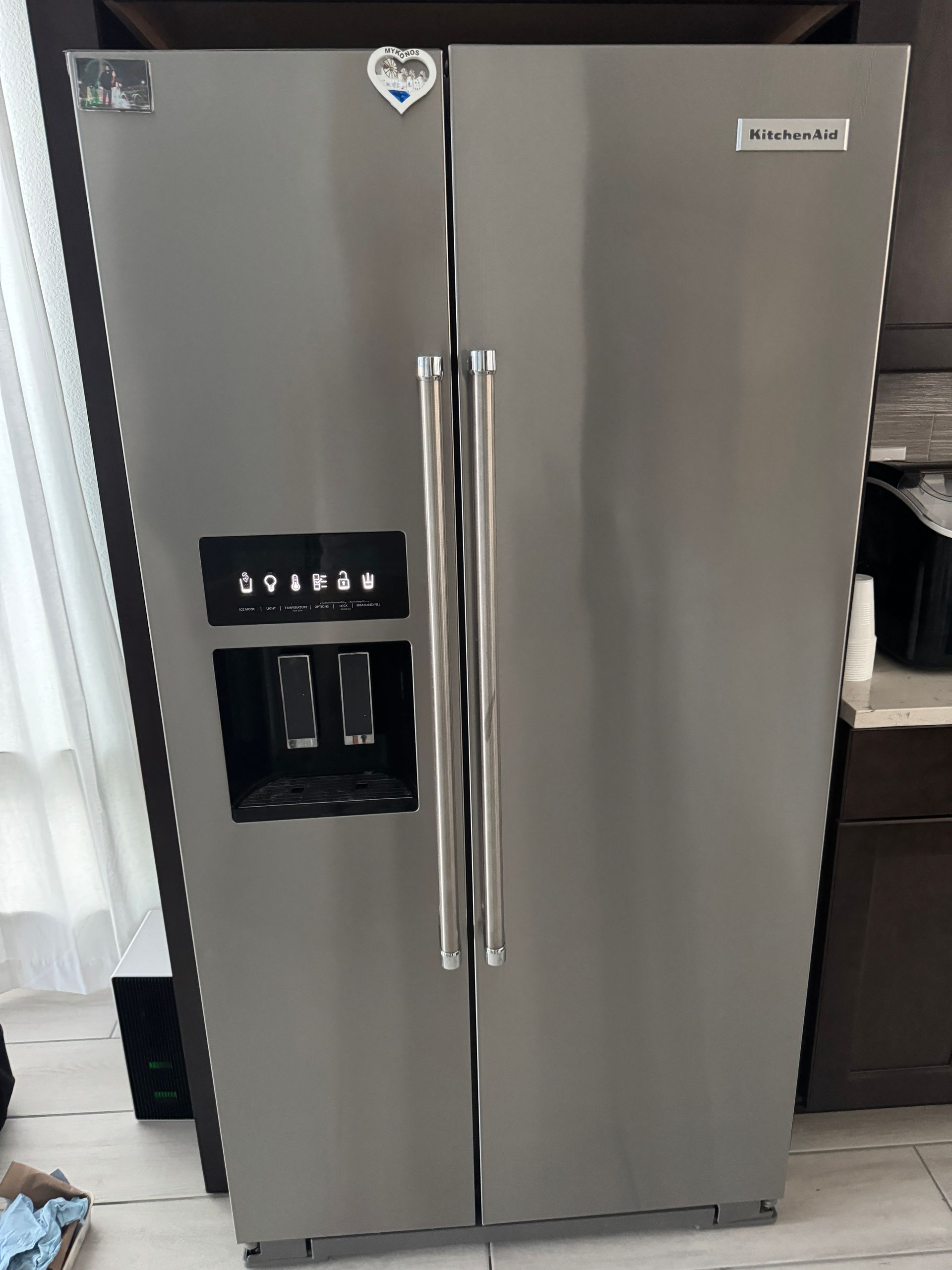 Stainless steel KitchenAid side-by-side refrigerator with water/ice dispenser.