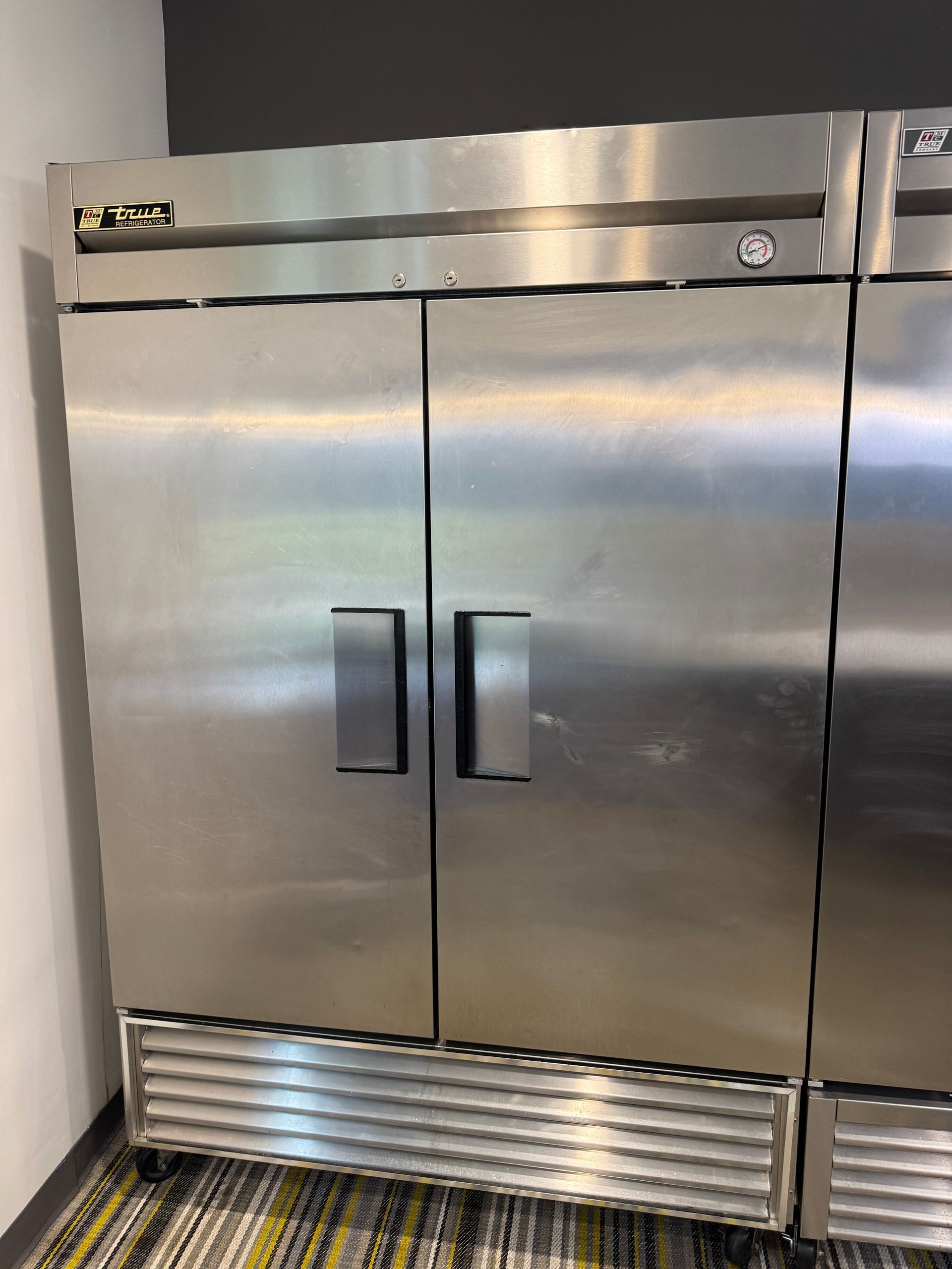 Stainless steel commercial refrigerator with two doors.