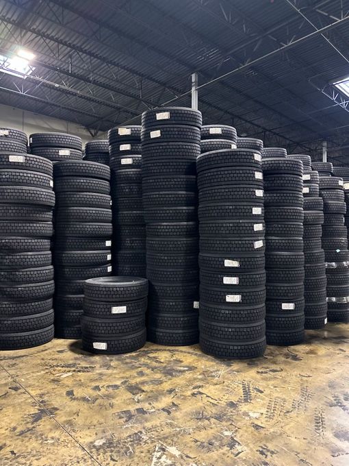 A warehouse filled with lots of tires stacked on top of each other.