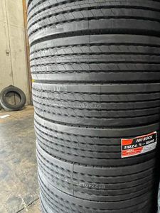 A pile of tires stacked on top of each other in a garage.