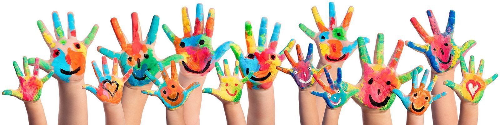 A group of children 's hands painted in different colors with smiley faces on them.