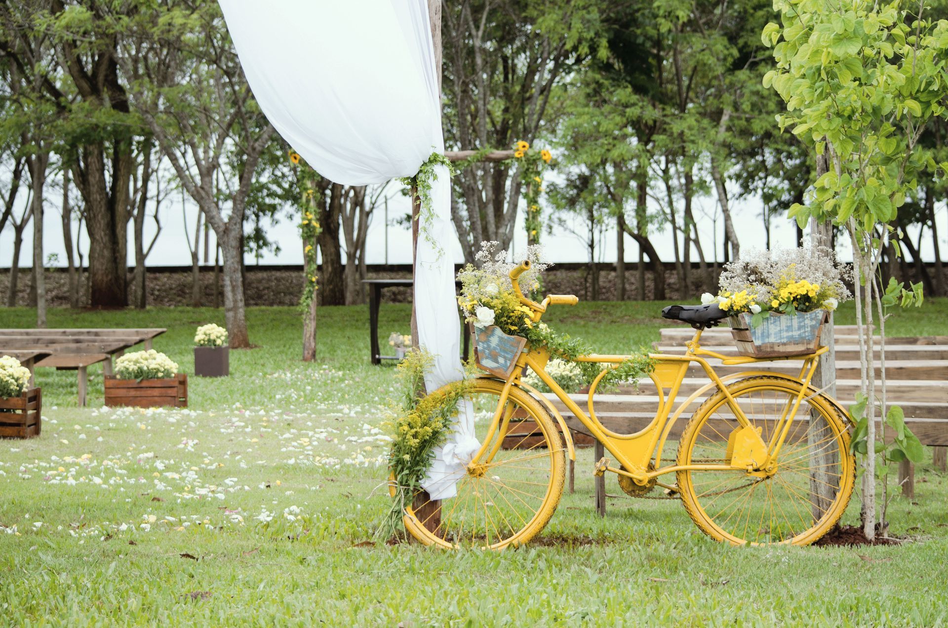 A yellow bicycle is sitting on top of a lush green field.