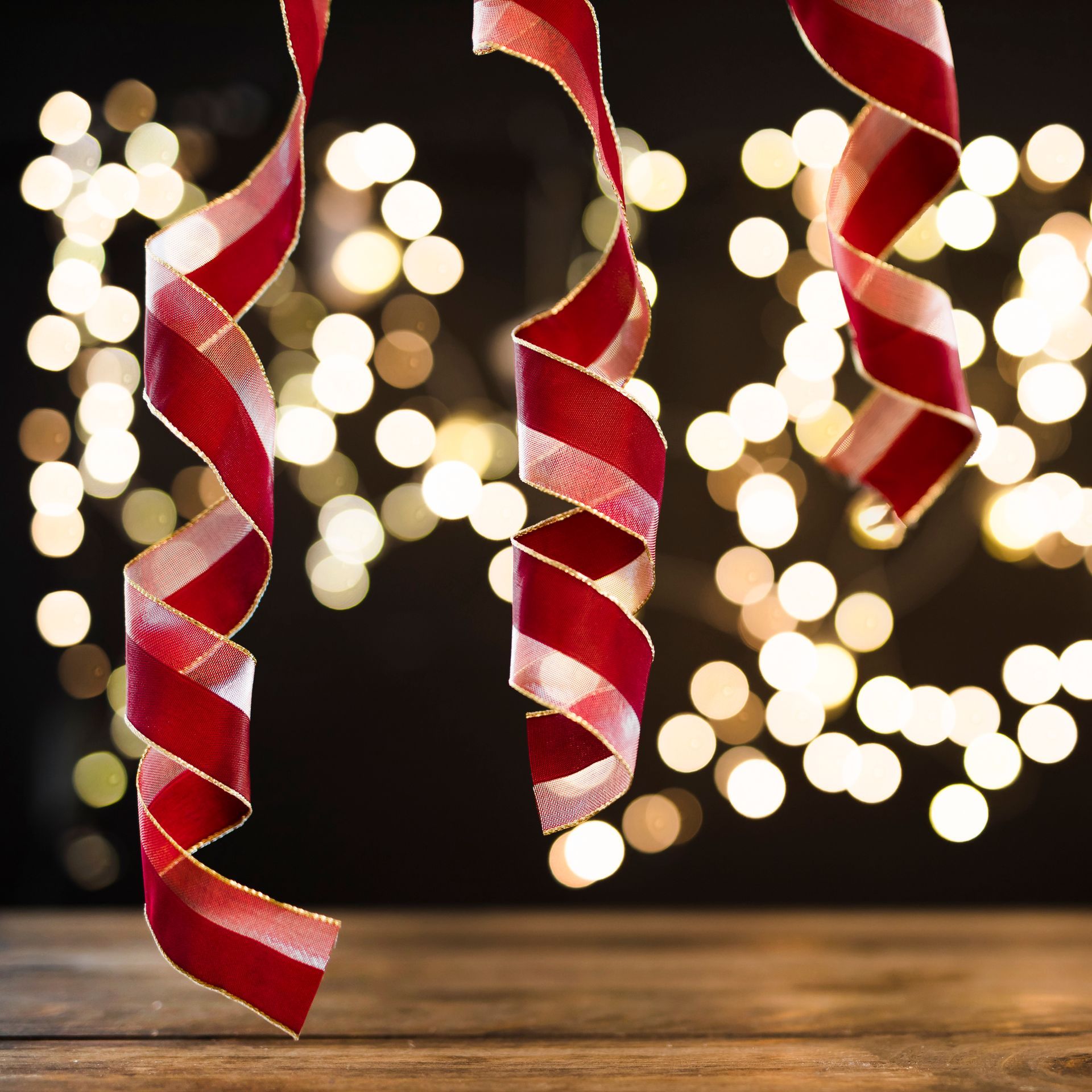 A bunch of red ribbons are hanging from a string