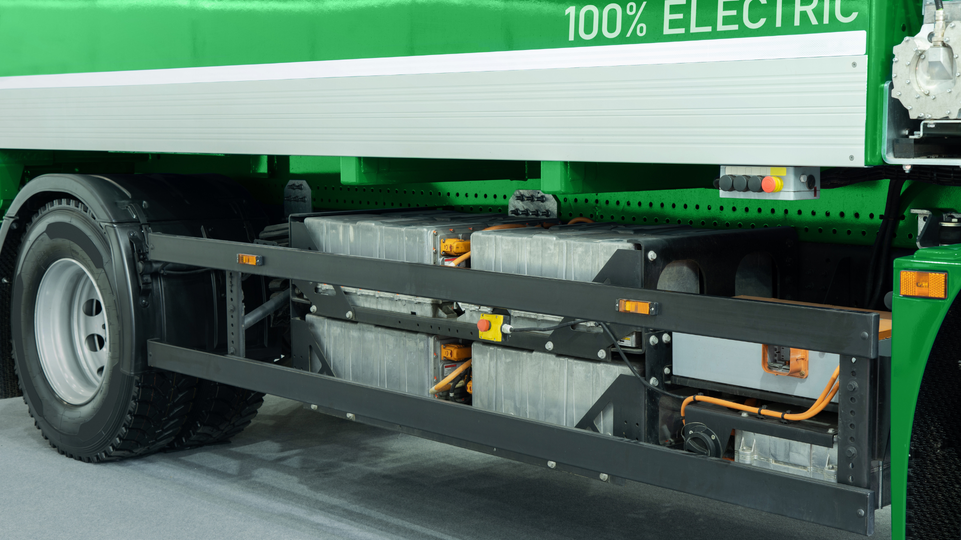 A green truck with the words 100 % electric on the side