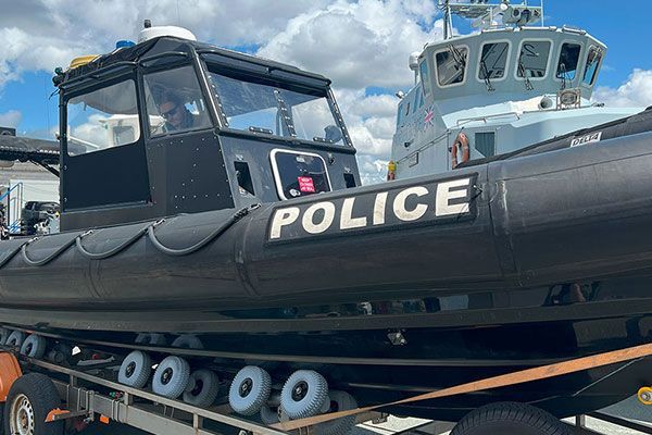 a police boat is sitting on top of a trailer .