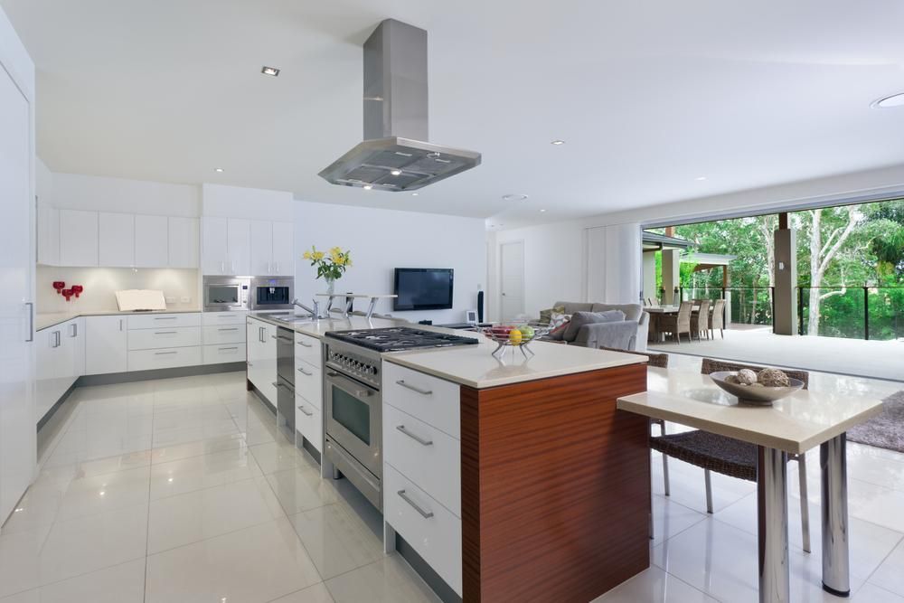 A Kitchen with White Cabinets and Stainless Steel Appliances — Smith's Joinery in Yamba, NSW