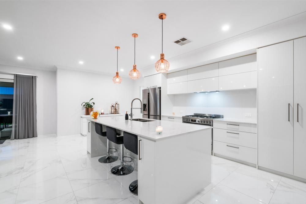 A Kitchen with White Cabinets and A Large Island in The Middle — Smith's Joinery in Murwillumbah, NSW