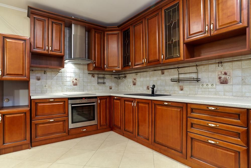 A Kitchen with Wooden Cabinets, Stainless Steel Appliances, a Sink, and A Microwave Oven — Smith's Joinery in Yamba, NSW