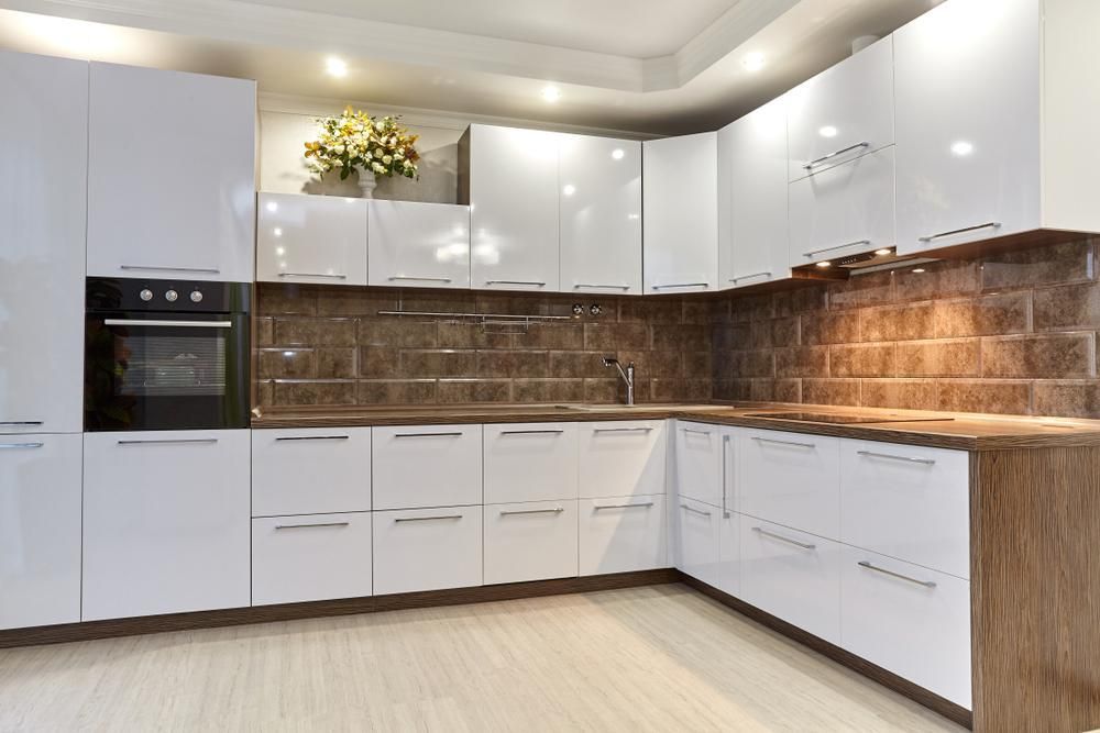 A Kitchen with White Cabinets and A Black Oven — Smith's Joinery in Mullumbimby, NSW