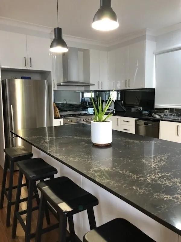 A Kitchen with Stools and A Plant on The Counter — Smith's Joinery in Mullumbimby, NSW