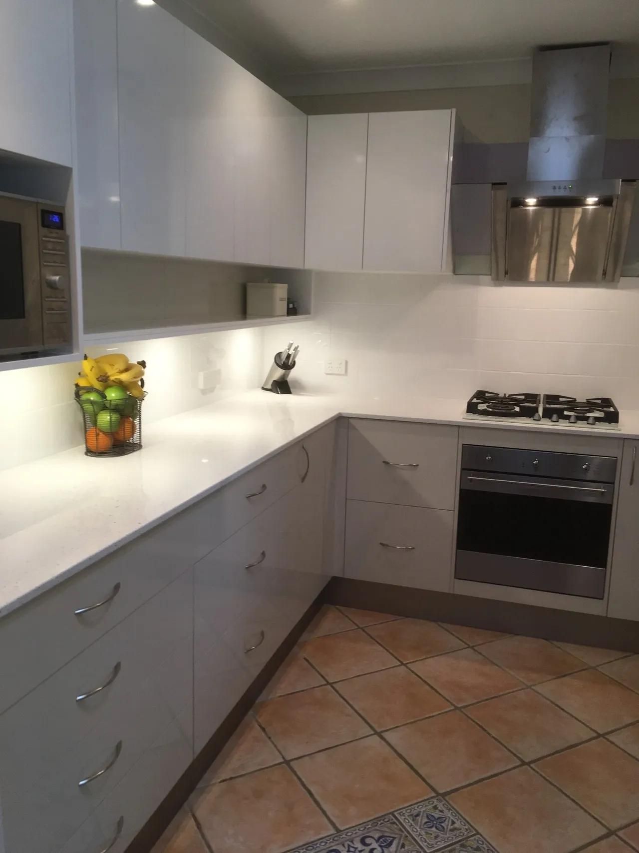 A Kitchen with White Cabinets and A Stove Top Oven — Smith's Joinery in Casino, NSW
