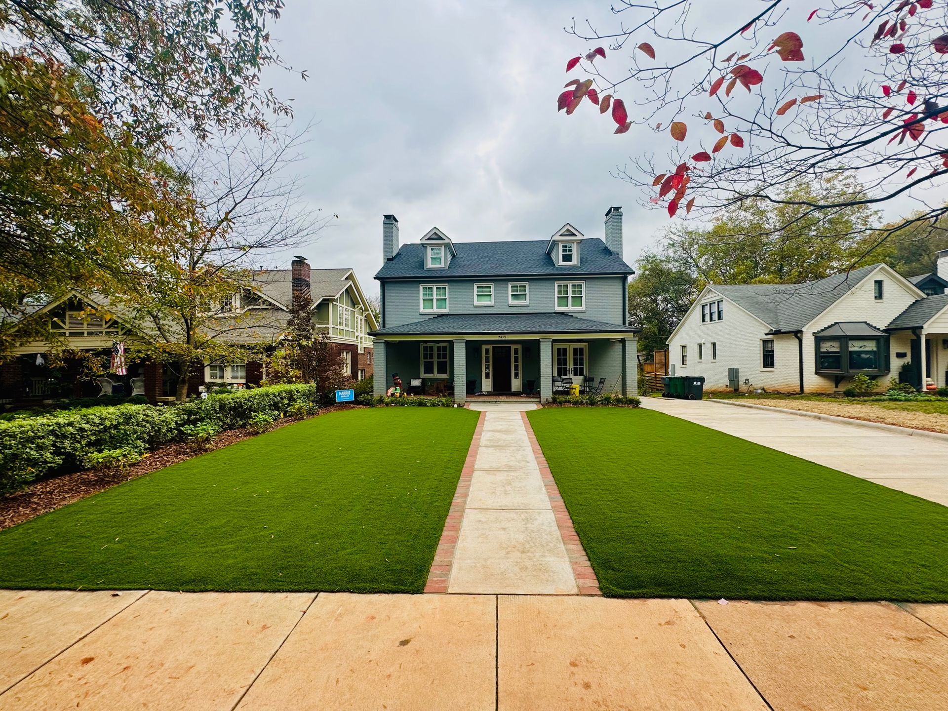 A large house with a lush green lawn in front of it