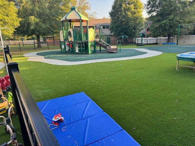 A playground with a blue mat in the middle of it