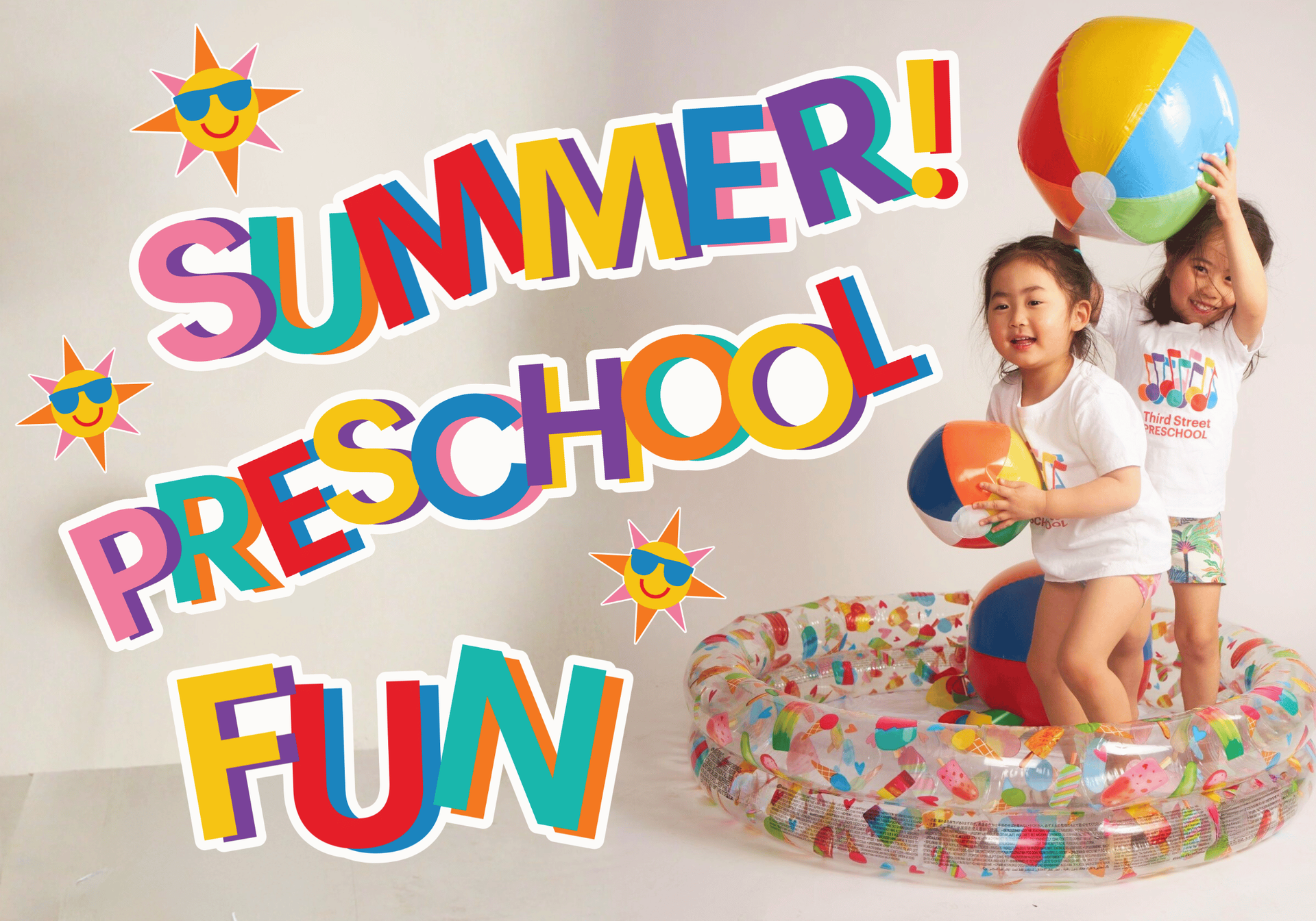A little girl is sitting on a blue ball in a playground.