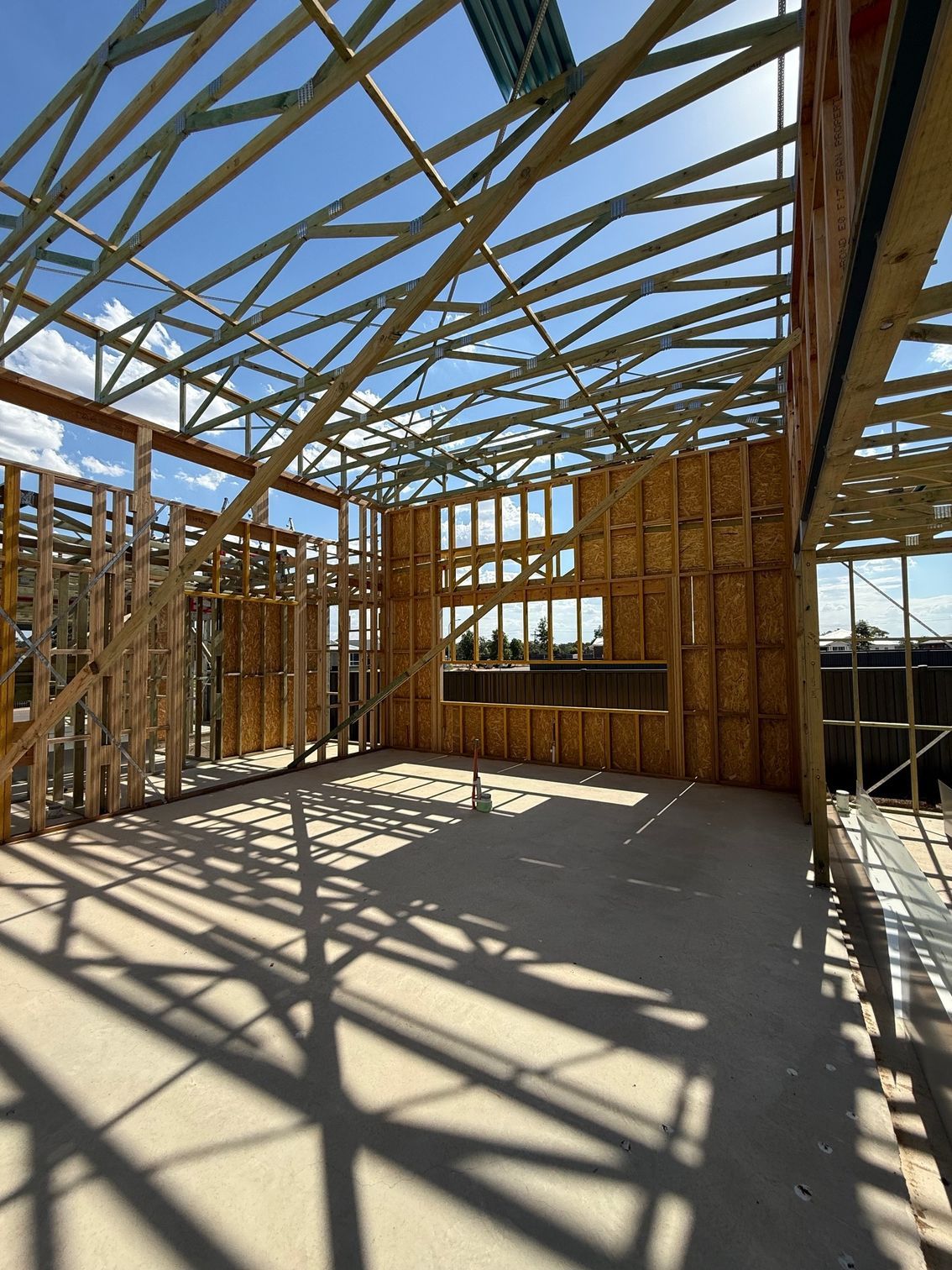 The inside of a building under construction with a blue sky in the background.