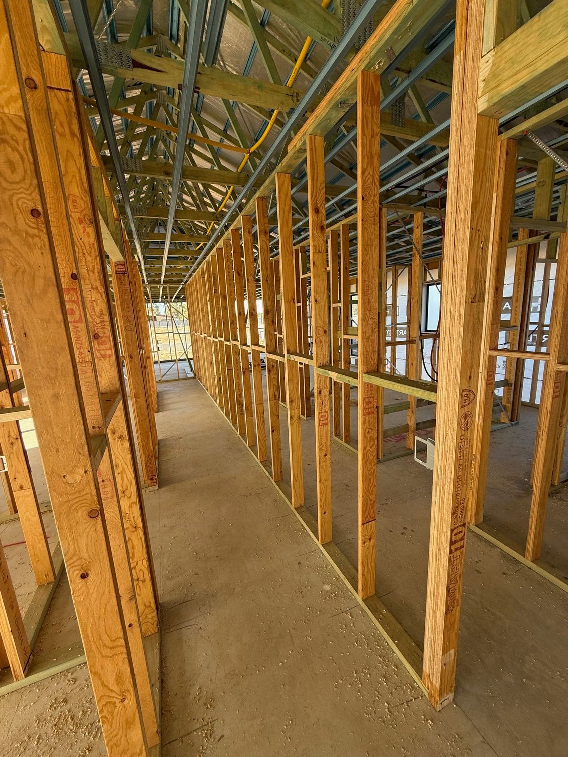 The inside of a building under construction with wooden beams.