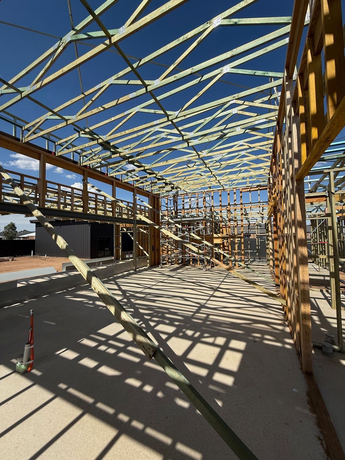 A large building under construction with a blue sky in the background