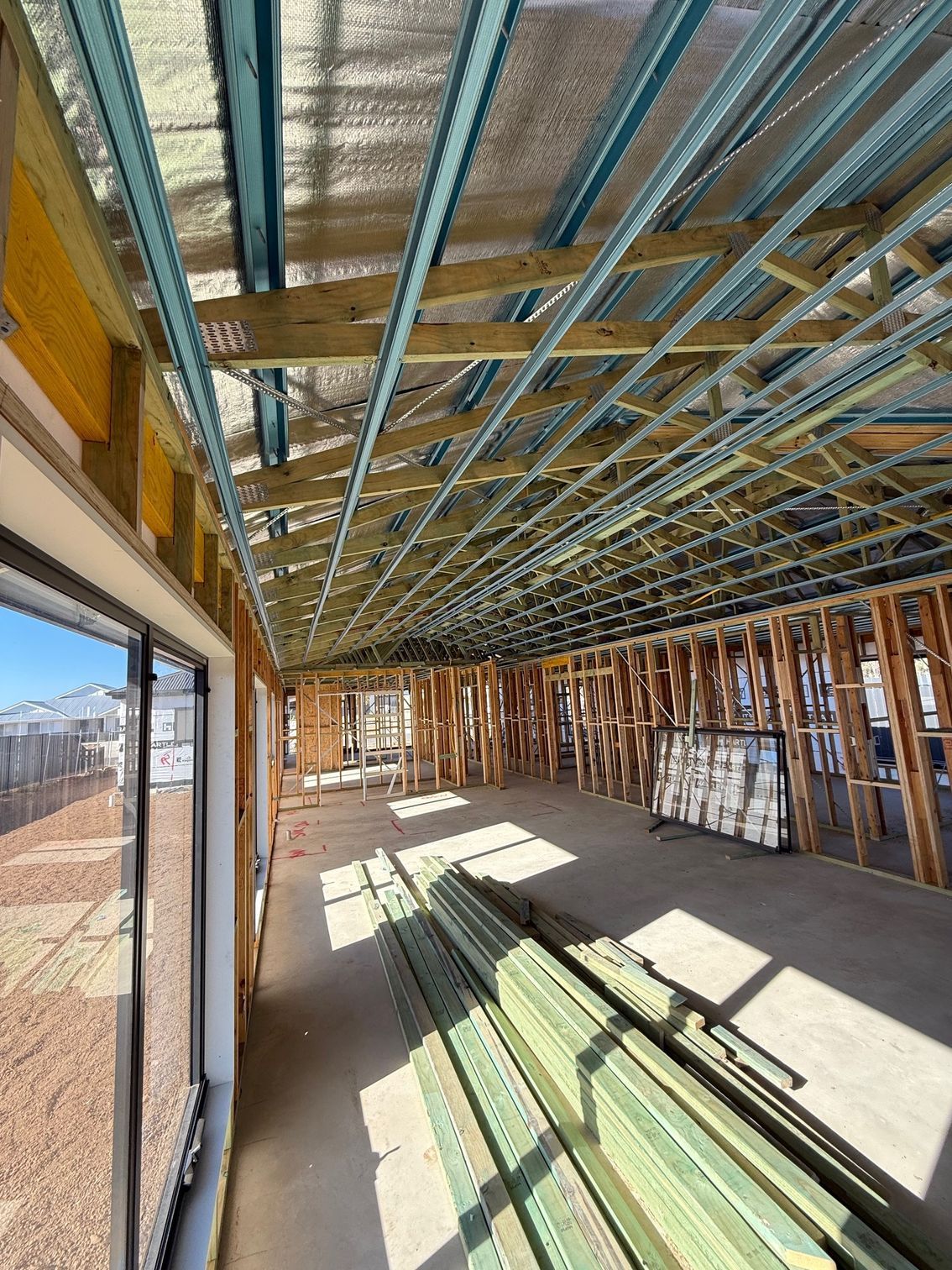 The inside of a building under construction with a lot of wooden beams.