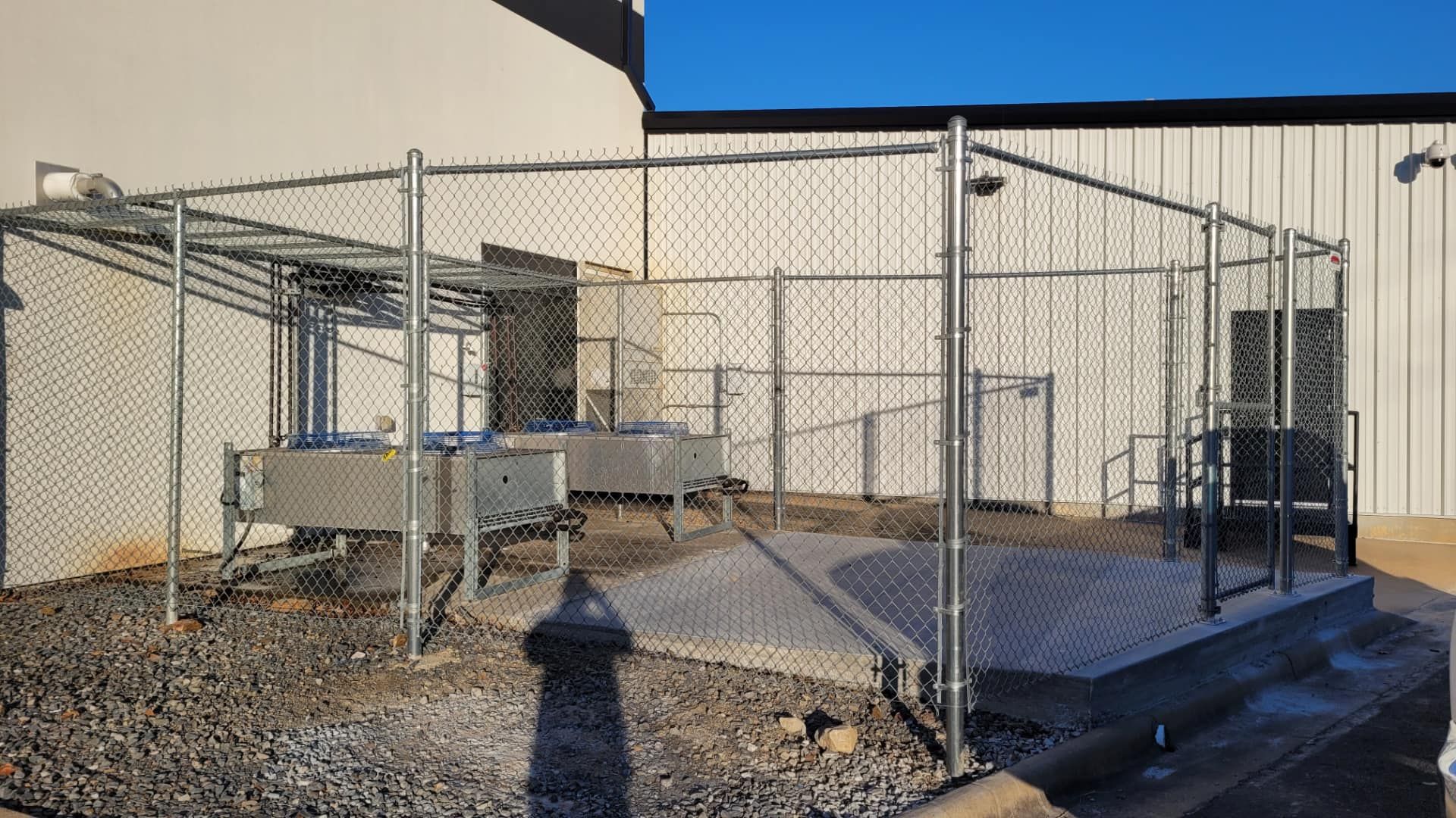 A chain link fence is in front of a building.