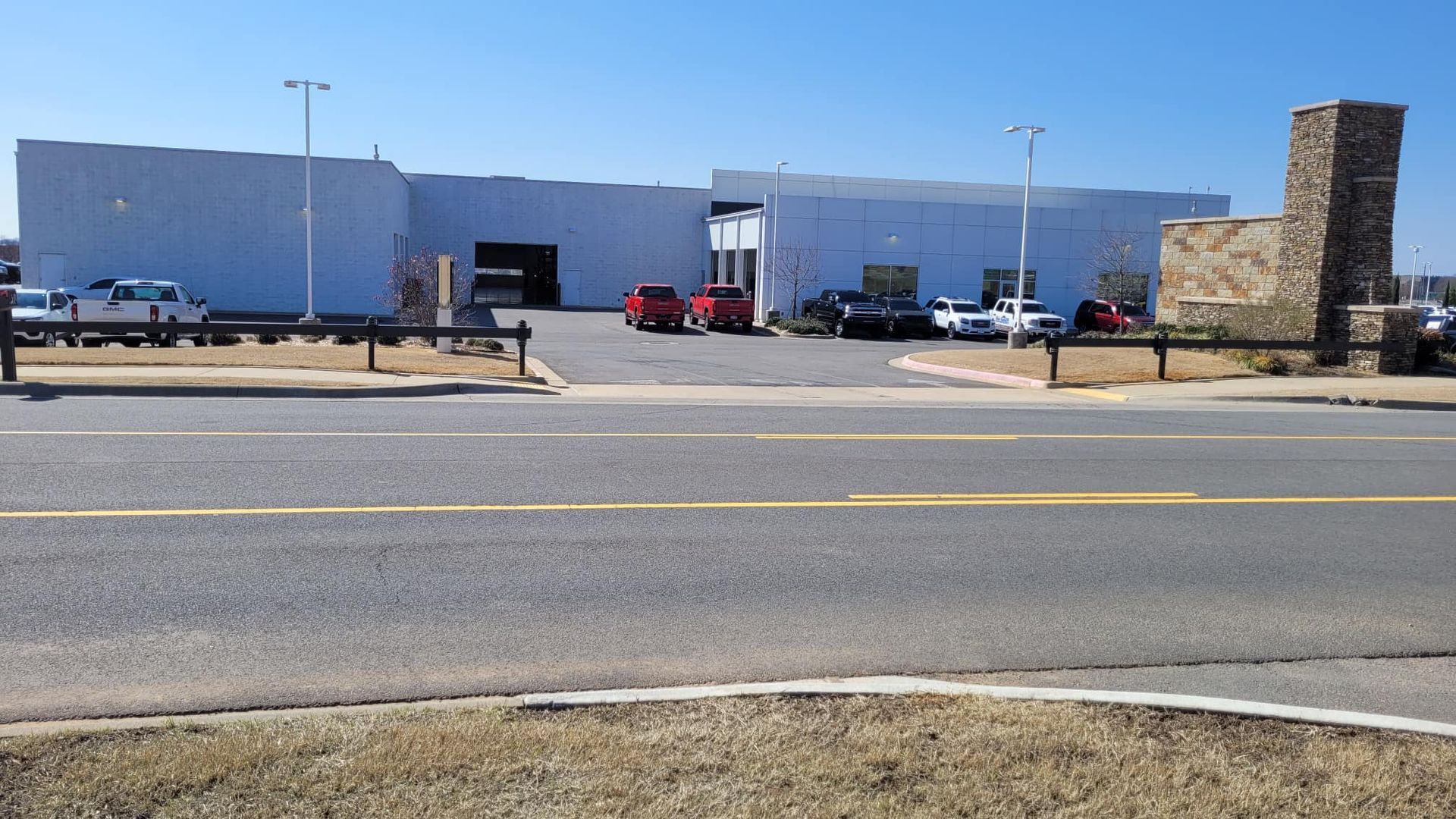 A large white building with cars parked in front of it