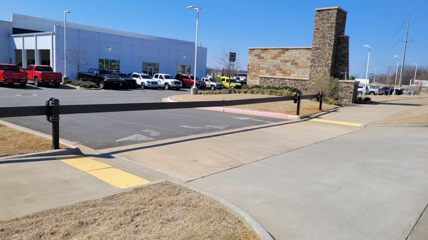 A parking lot with cars parked in front of a building