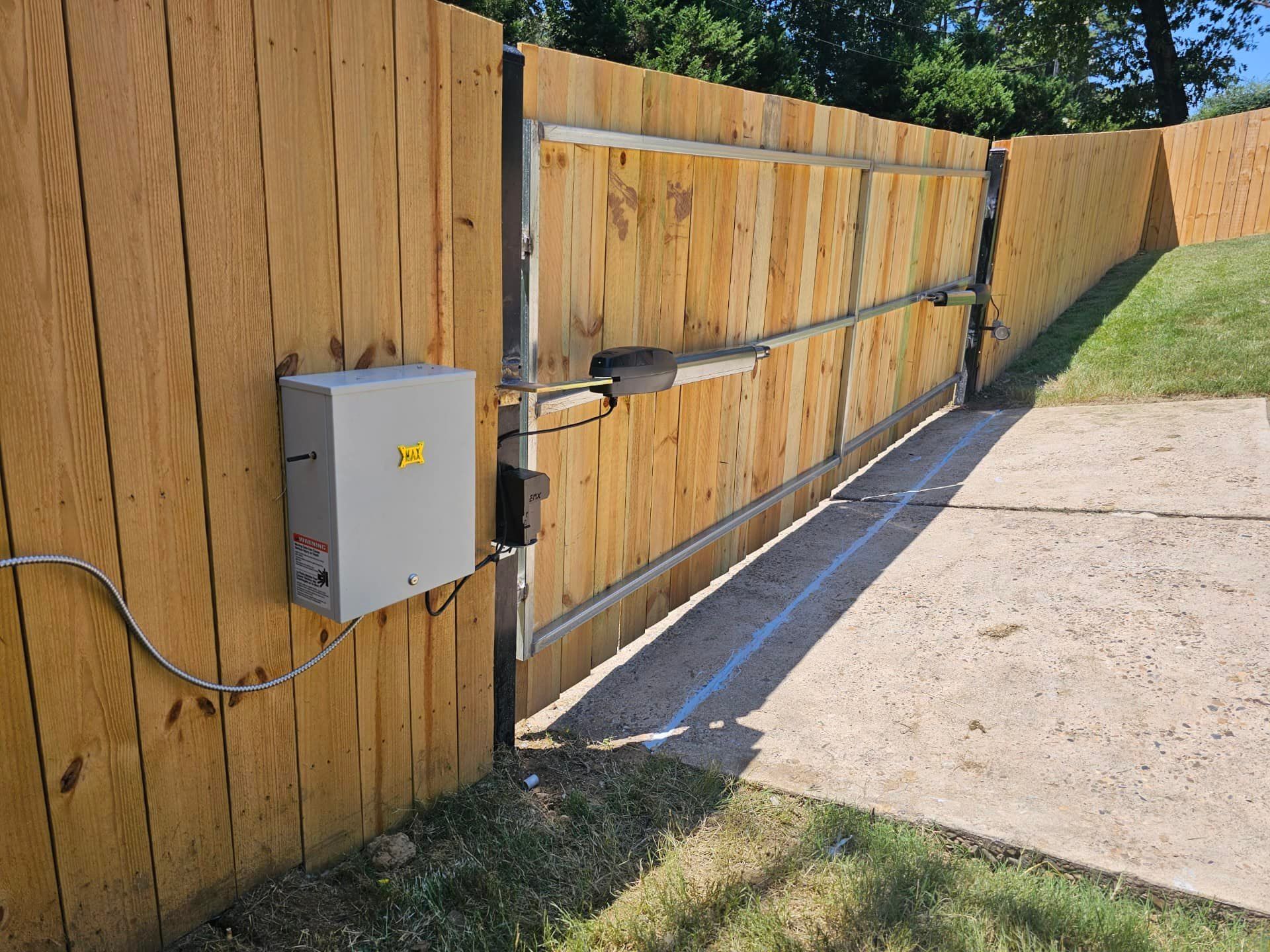 A wooden fence with a gate and a box attached to it.