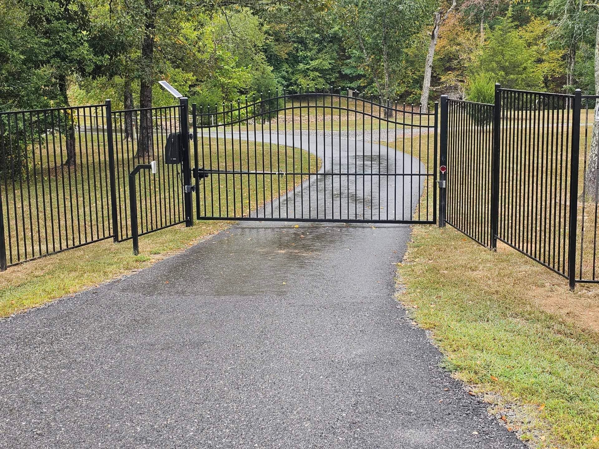 There is a gate on the side of the road.
