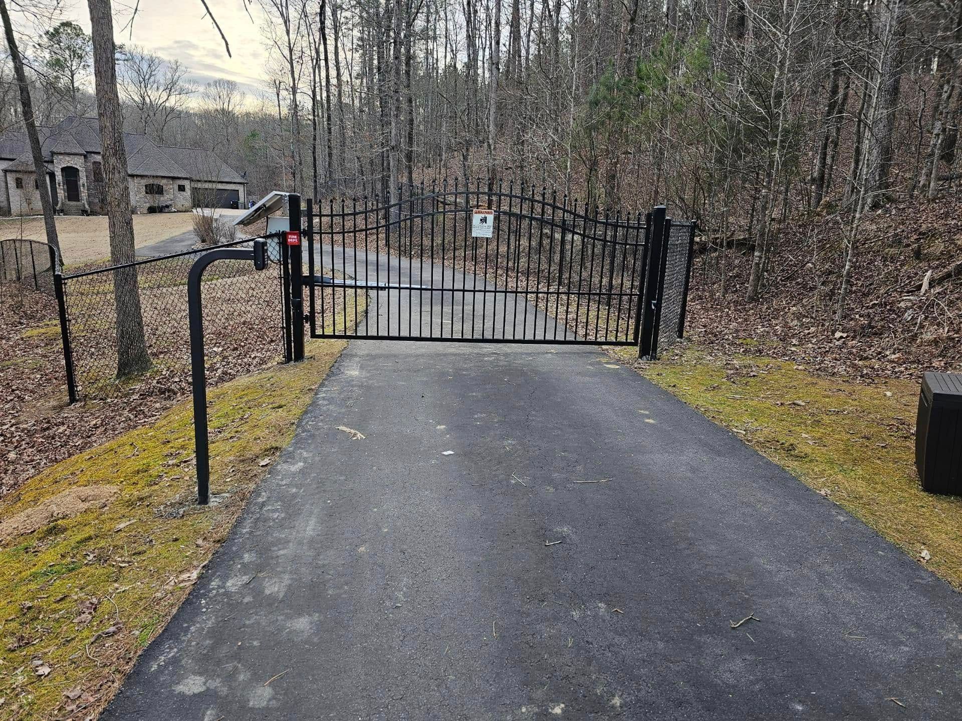 There is a gate on the side of the road.