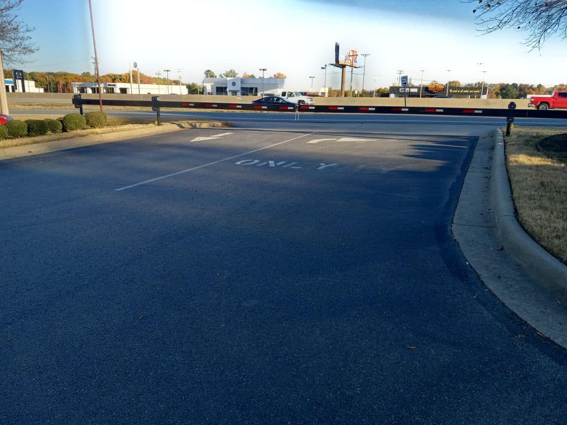 A road with a fence and a sign that says ' a ' on it