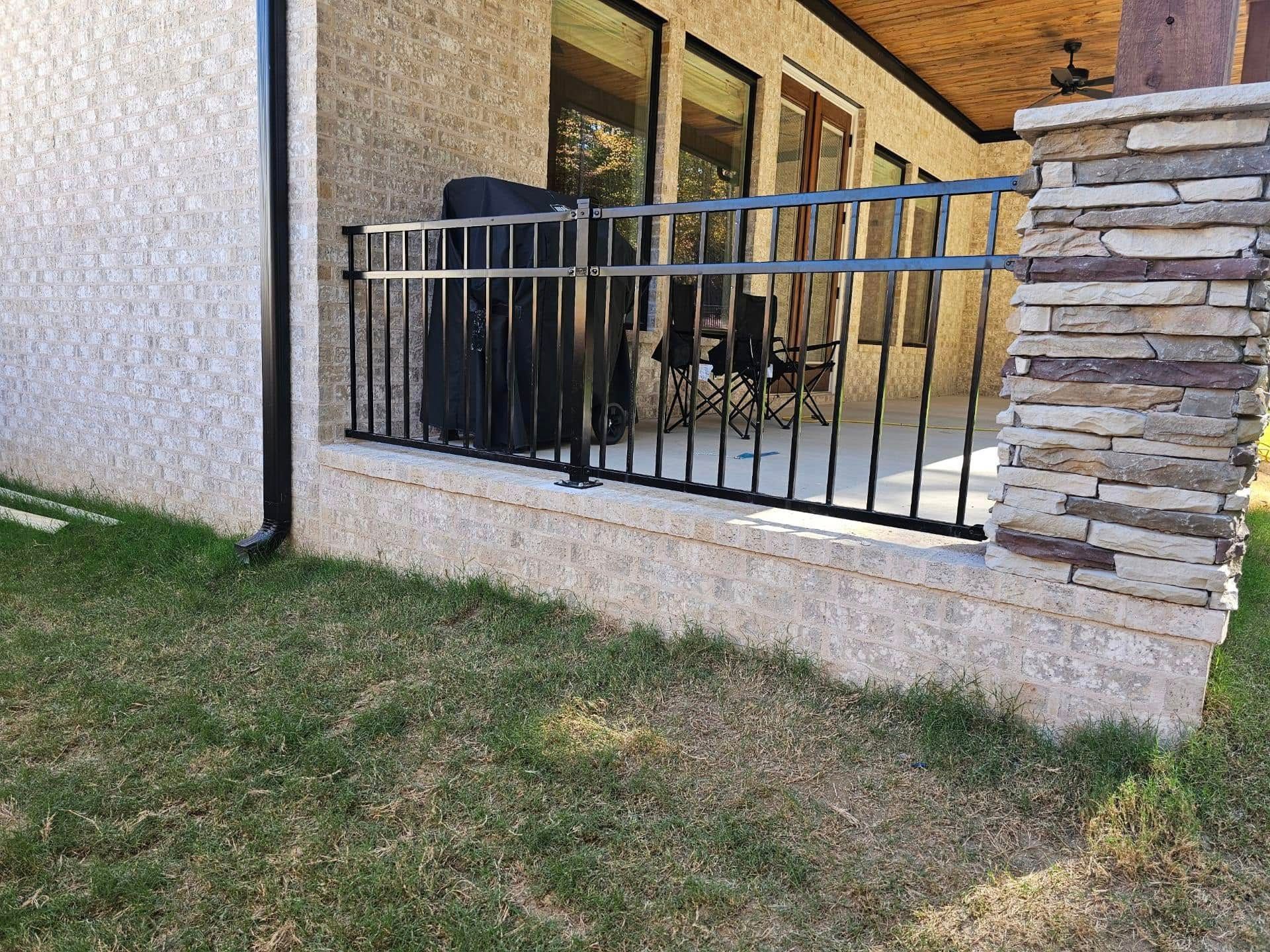 There is a balcony with a metal railing on the side of the house.