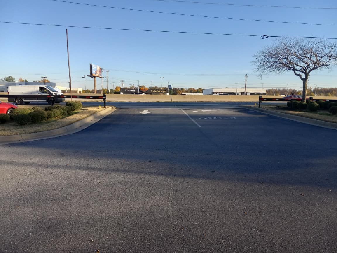 A red car is parked on the side of the road