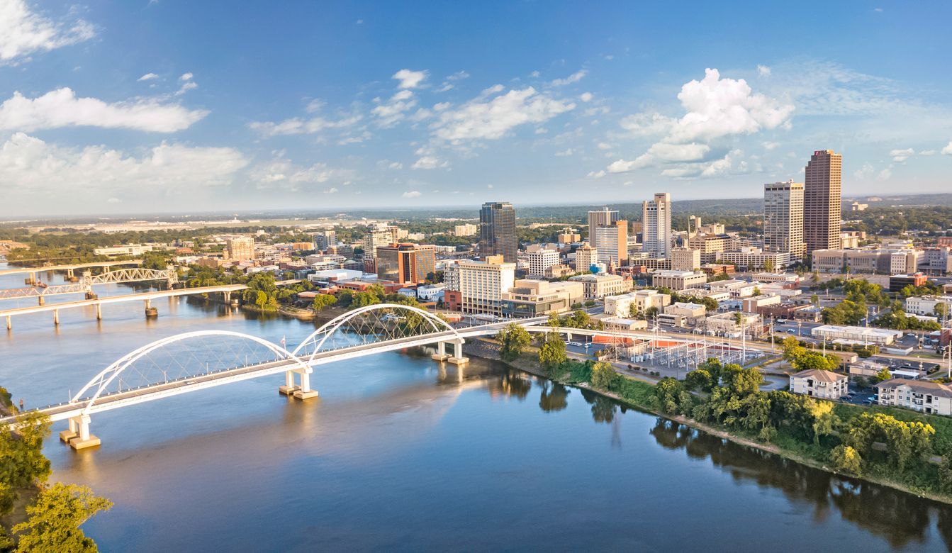 An aerial view of a city with a bridge over a river.