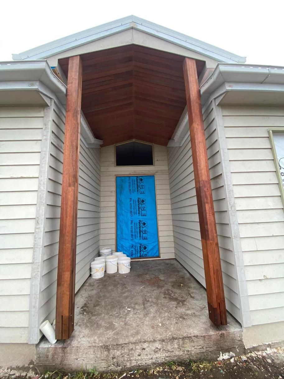 A House with A Blue Door and A Wooden Porch — Formosa Building And Renovations in South Kolan, QLD