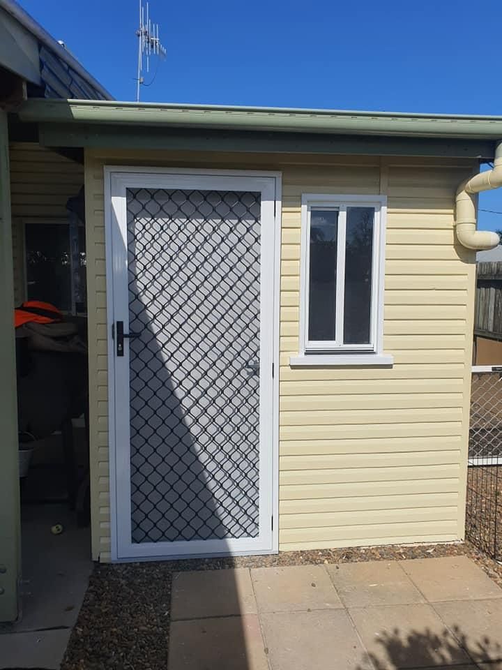 A Shed with A Screen Door and A Window — Formosa Building And Renovations in Woodgate, QLD