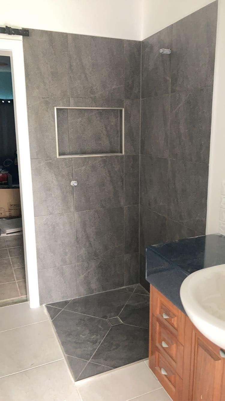 A Bathroom with A Walk in Shower and A Sink — Formosa Building And Renovations in Childers, QLD