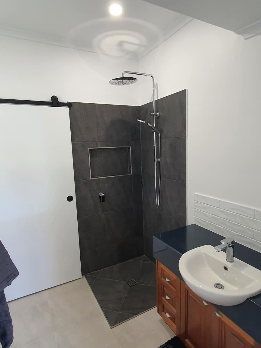 A Bathroom with A Sink and A Walk in Shower — Formosa Building And Renovations in Childers, QLD
