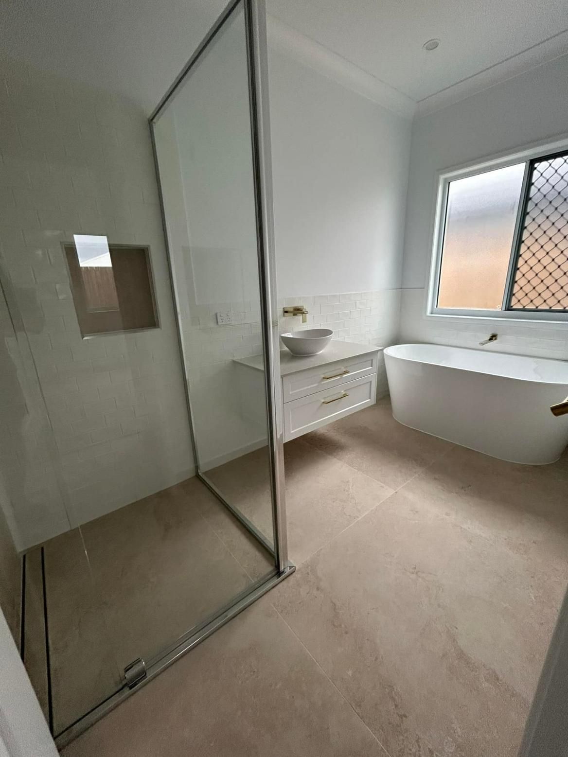 A Bathroom with A Bathtub, Sink, Shower and Window — Formosa Building And Renovations in Gin Gin, QLD